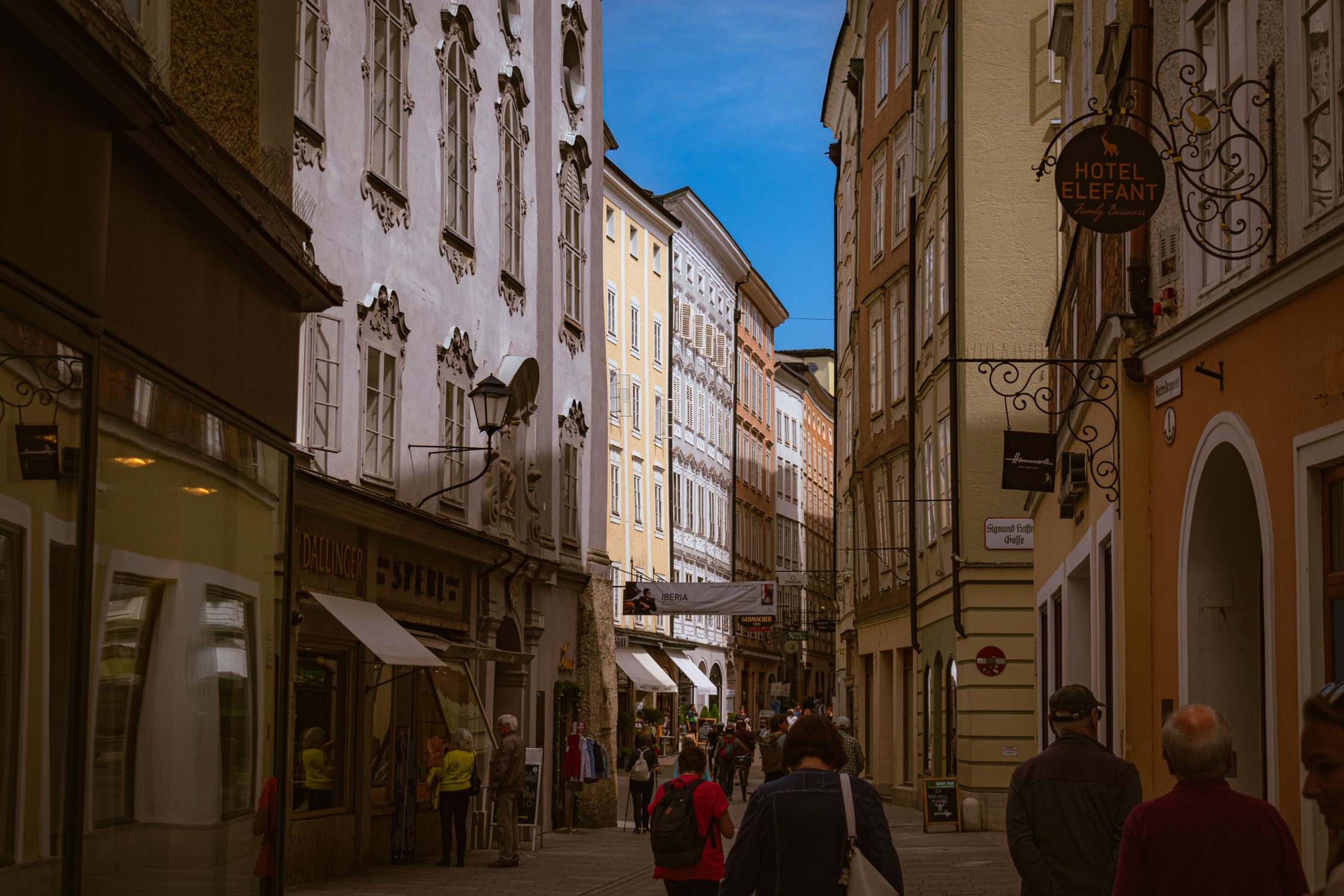 Vibrant street in a historic European old town showcasing architecture and tourists.