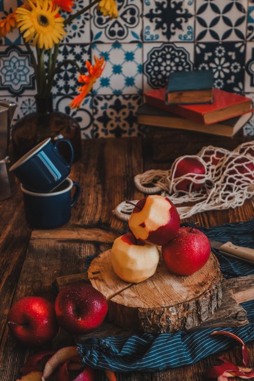 Free Rustic kitchen setup with apples on a wooden board, evoking a cozy atmosphere. Stock Photo
