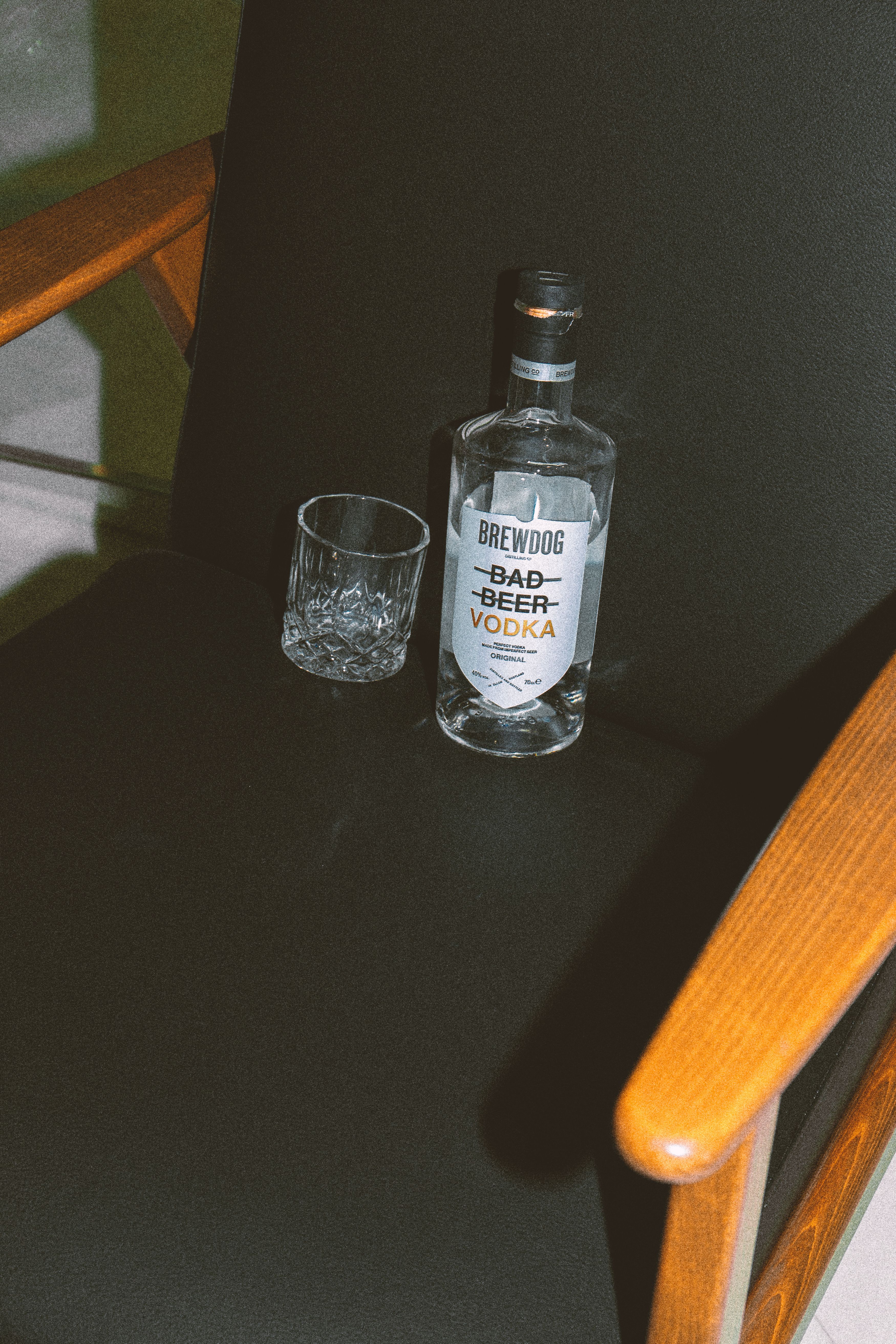 Vodka Bottle and Glass on Chair · Free Stock Photo