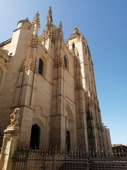 Explore the majestic gothic architecture of Segovia Cathedral on a sunny day in Spain.