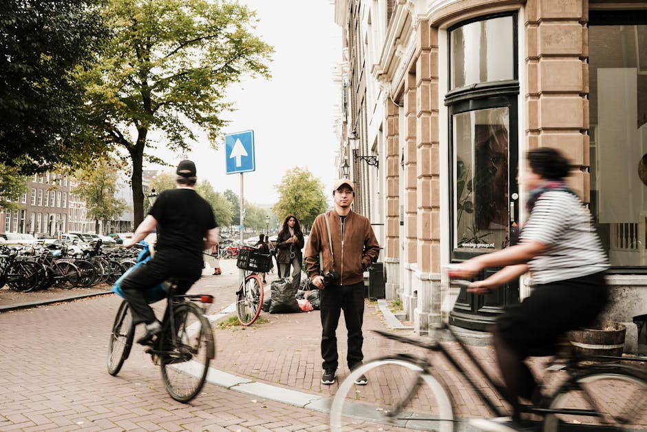 Man in Jacket behind People on Bicycles