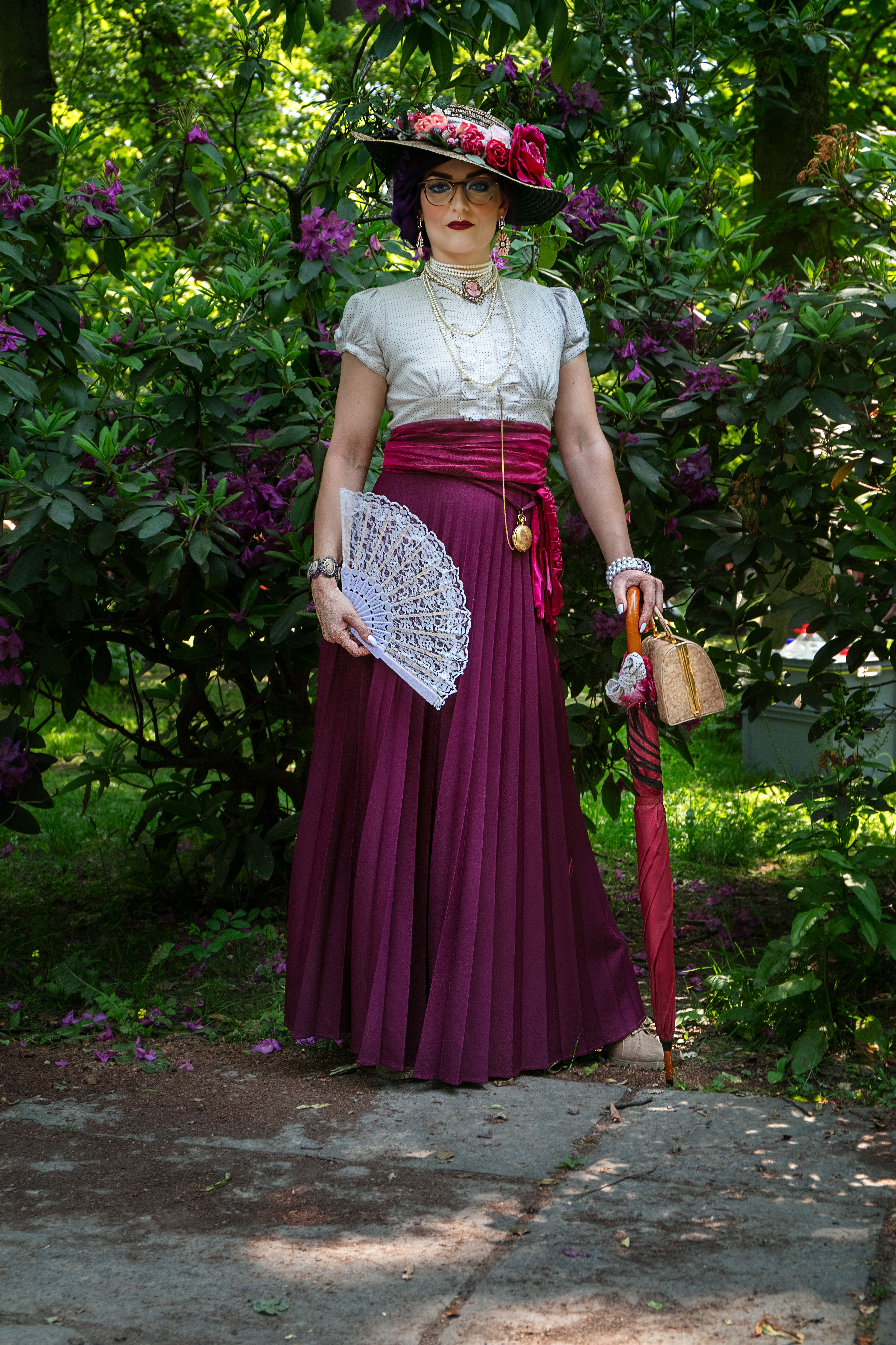 A woman in a victorian dress and hat is standing in the bushes · Free ...