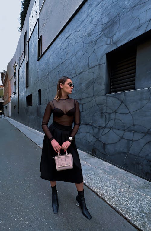 Model Posing in Black Dress and with Bag