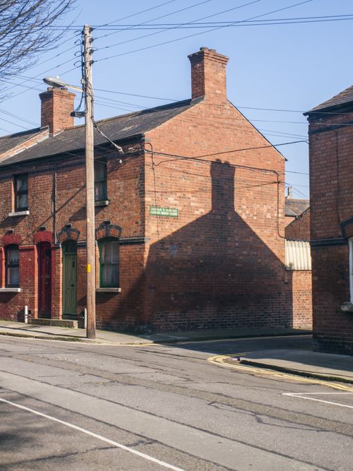 Free Charming red brick houses on a quiet Dublin street on a sunny day. Stock Photo