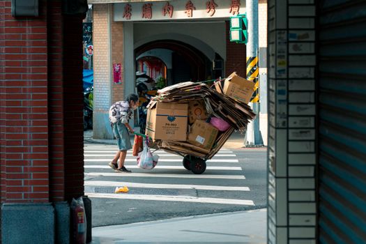 Man Towing Trailer with Cartoons on Street