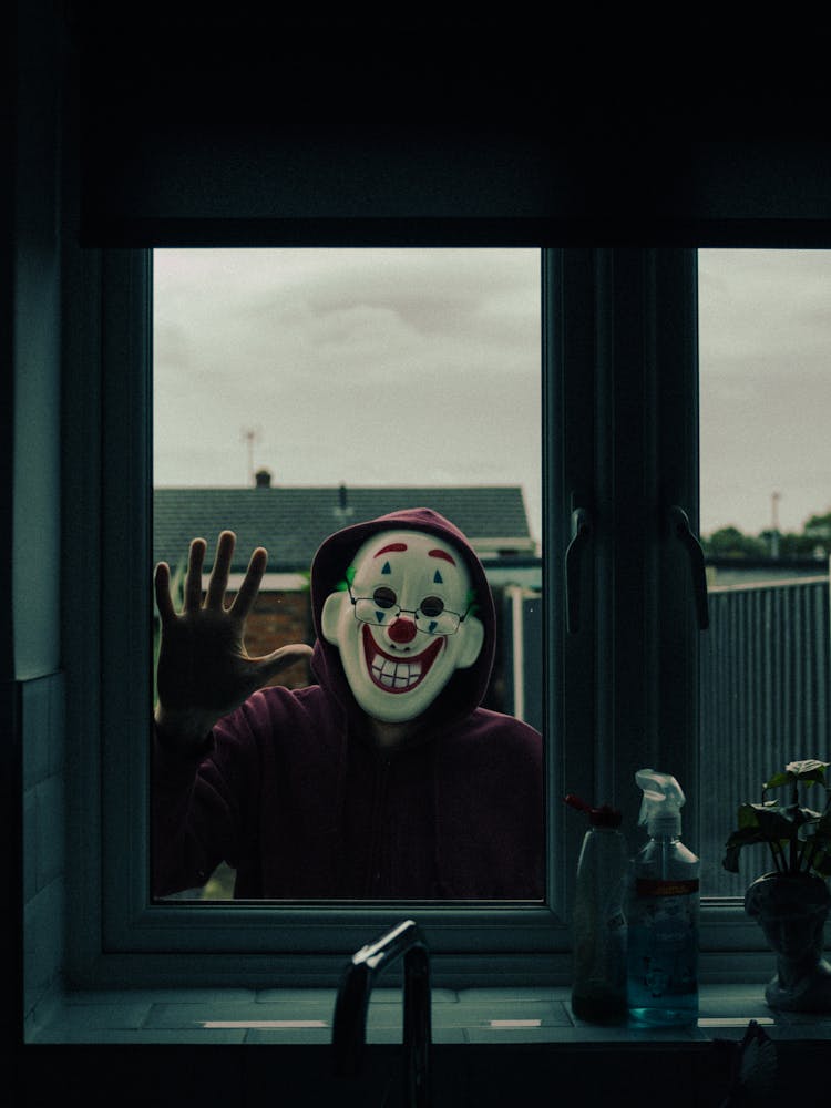 Man In A Mask Looking In Through The Window 