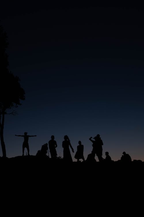 Silhouettes of People at Night