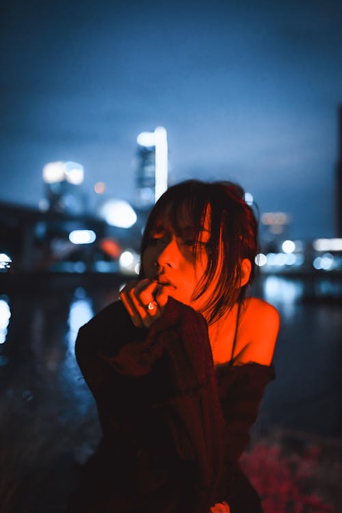 Portrait of Woman in Red Light in City at Night