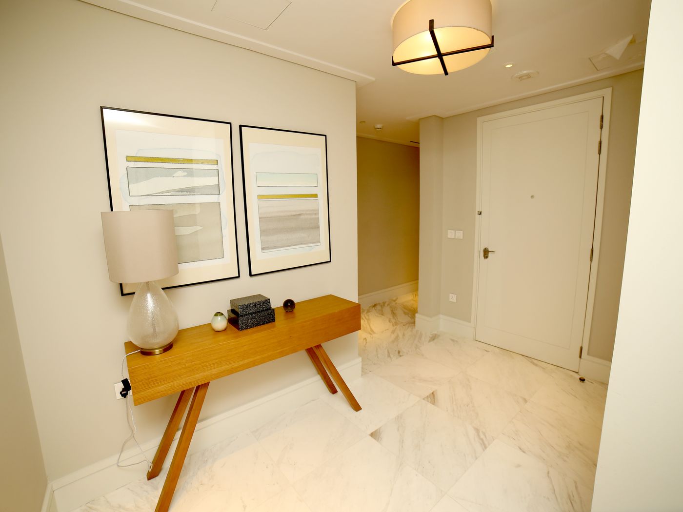 Refined entryway cabinet finish with warm wood metal accent and soft lighting