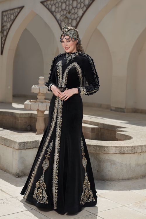 Free Woman in traditional embellished black dress outdoors in İzmir, showcasing Turkish style. Stock Photo