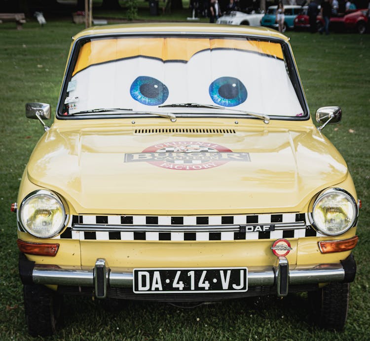 Vintage, Yellow Car With Eyes And Advertisement