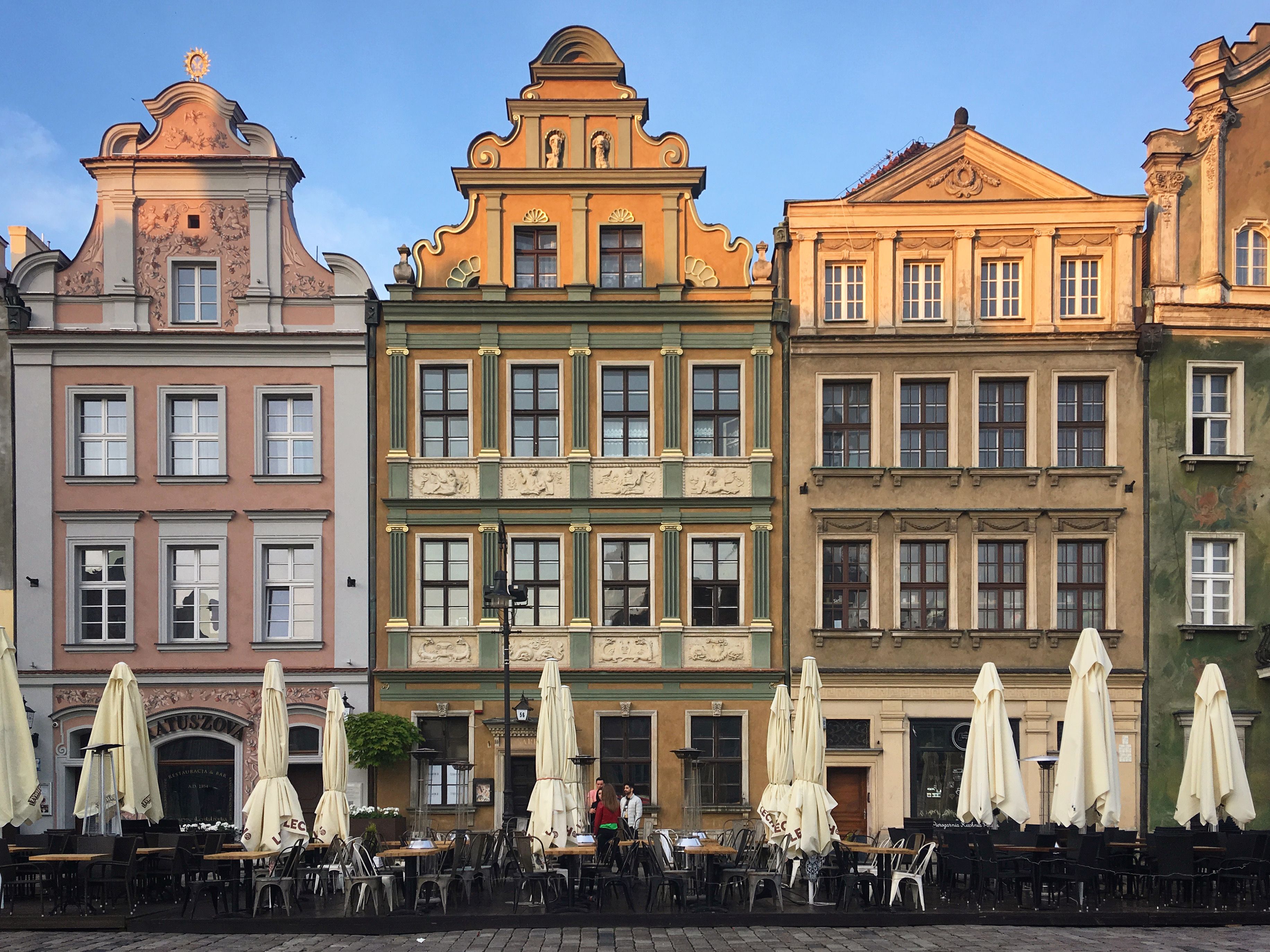 Colorful historic buildings in Old Market Square, Poznań, Poland captured during a sunny day.