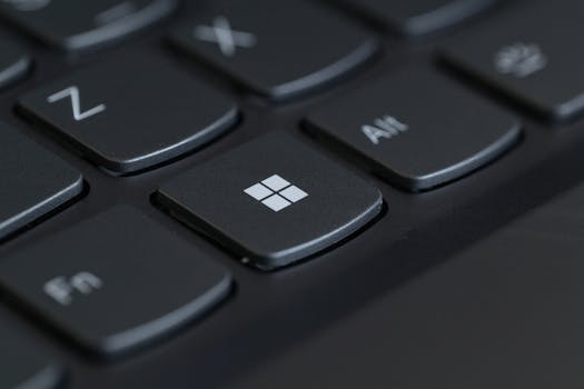Detailed close-up of a computer keyboard featuring the Windows key in focus.