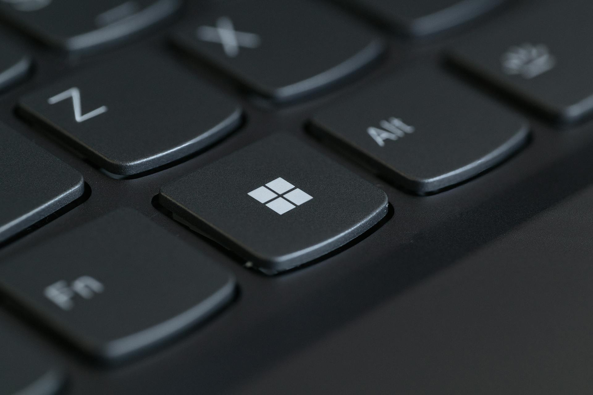 Detailed close-up of a computer keyboard featuring the Windows key in focus.