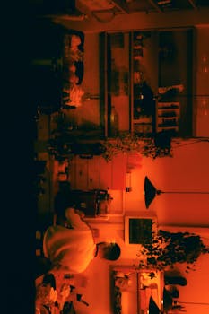 A person in a warmly lit kitchen interior creates a cozy atmosphere.