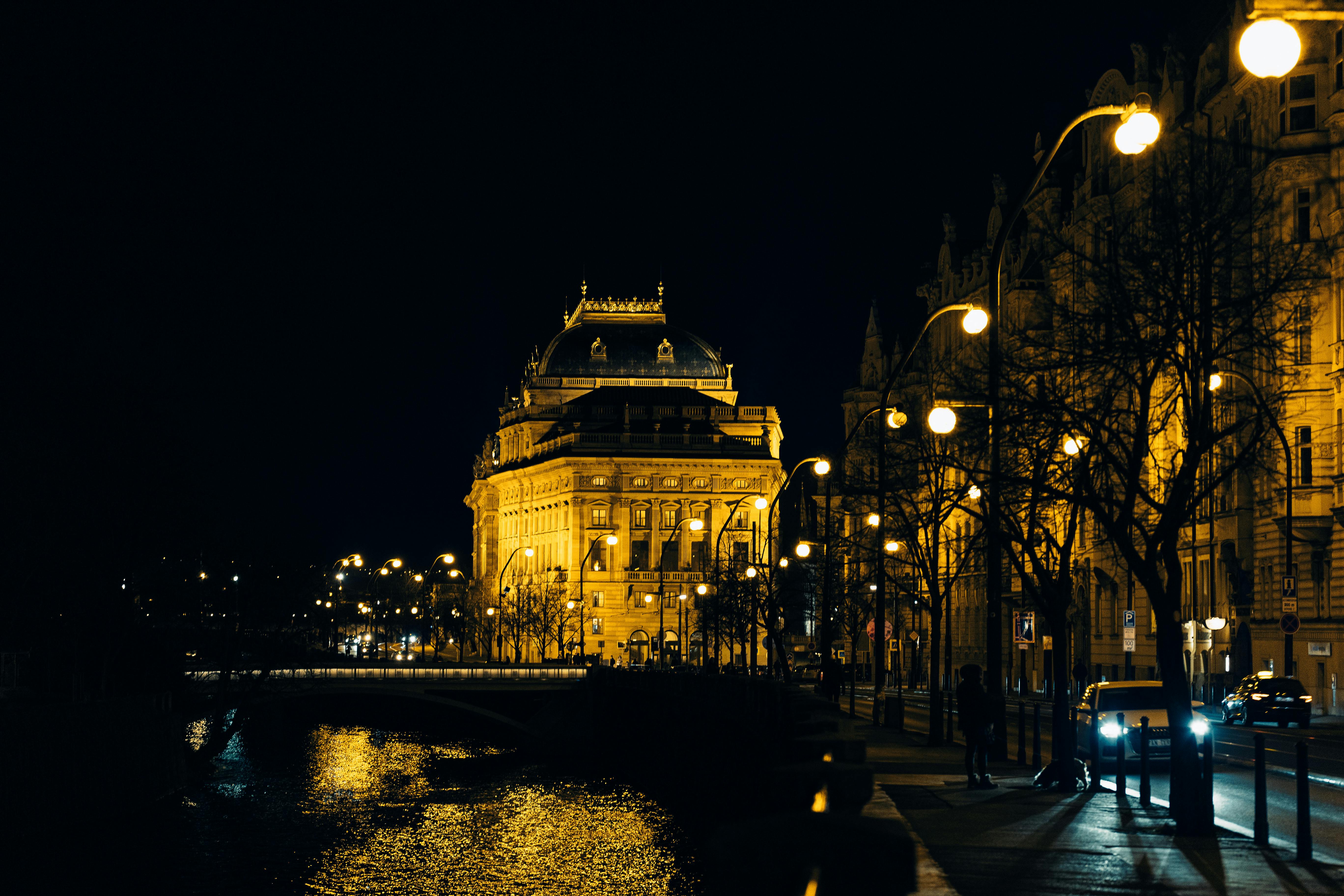 Free Nighttime view of the illuminated National Theater in Prague by the river. Stock Photo