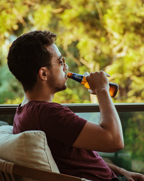 Man Sitting and Drinking Beer