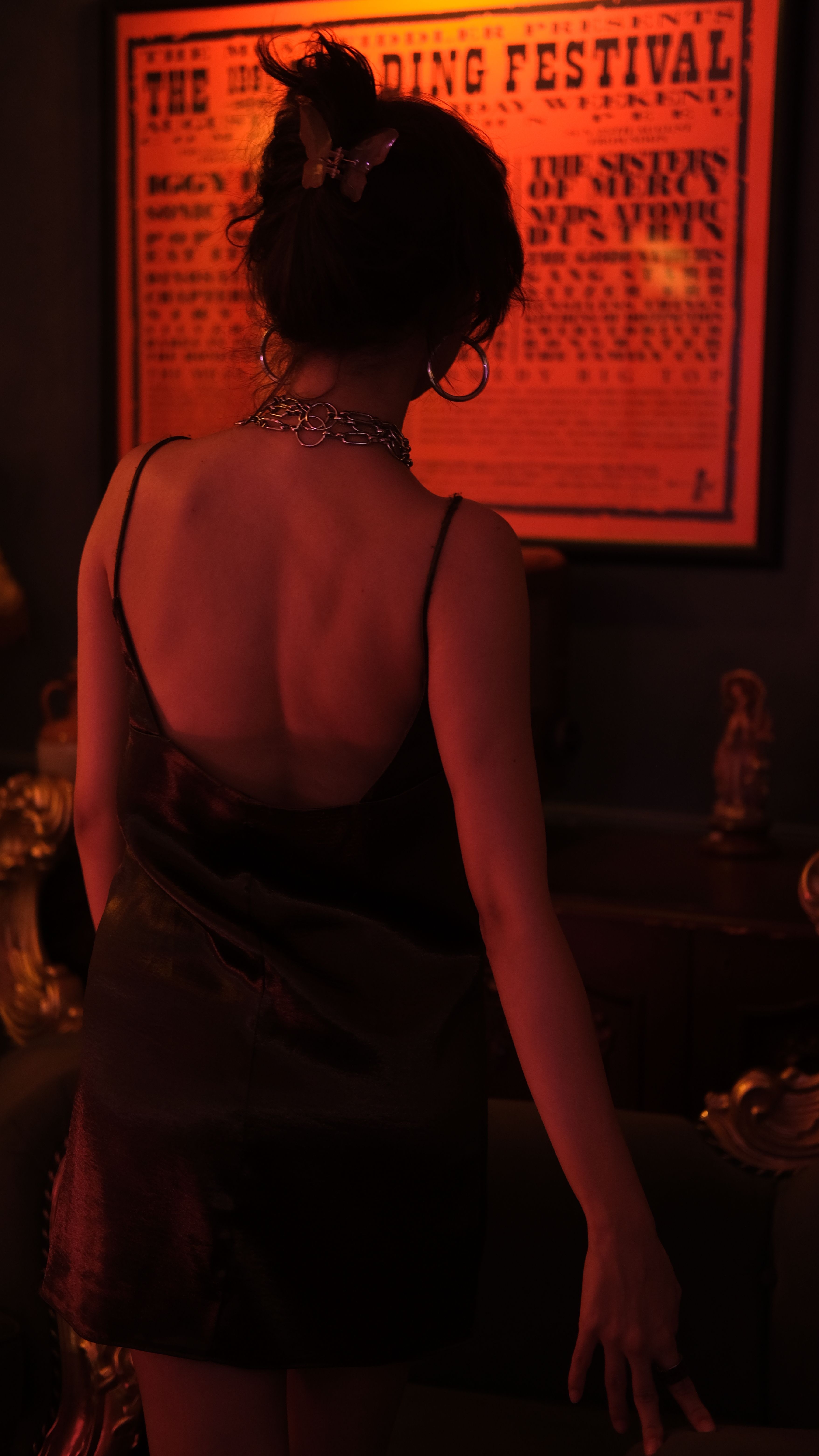 Back View of a Woman in a Black Dress Standing in Dim Light · Free ...