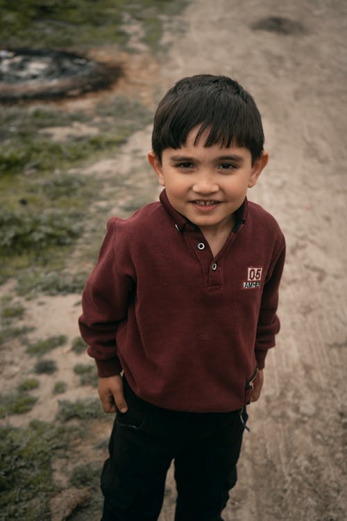 Smiling Boy Standing on Dirt Road