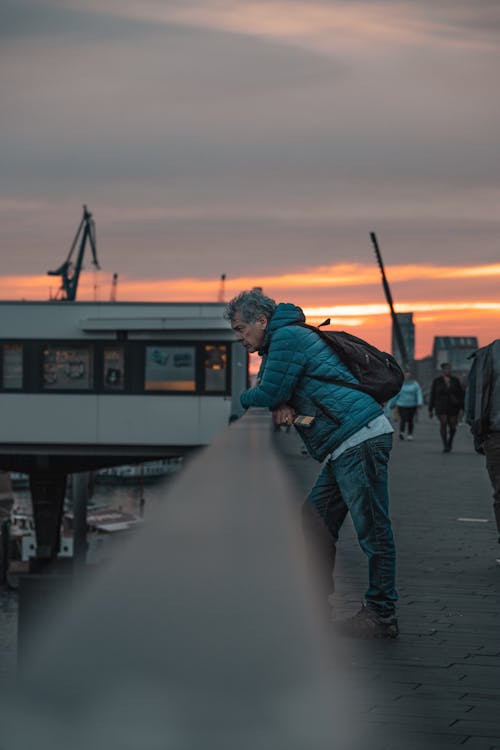 Man Standing on a Bridge at Sunset 