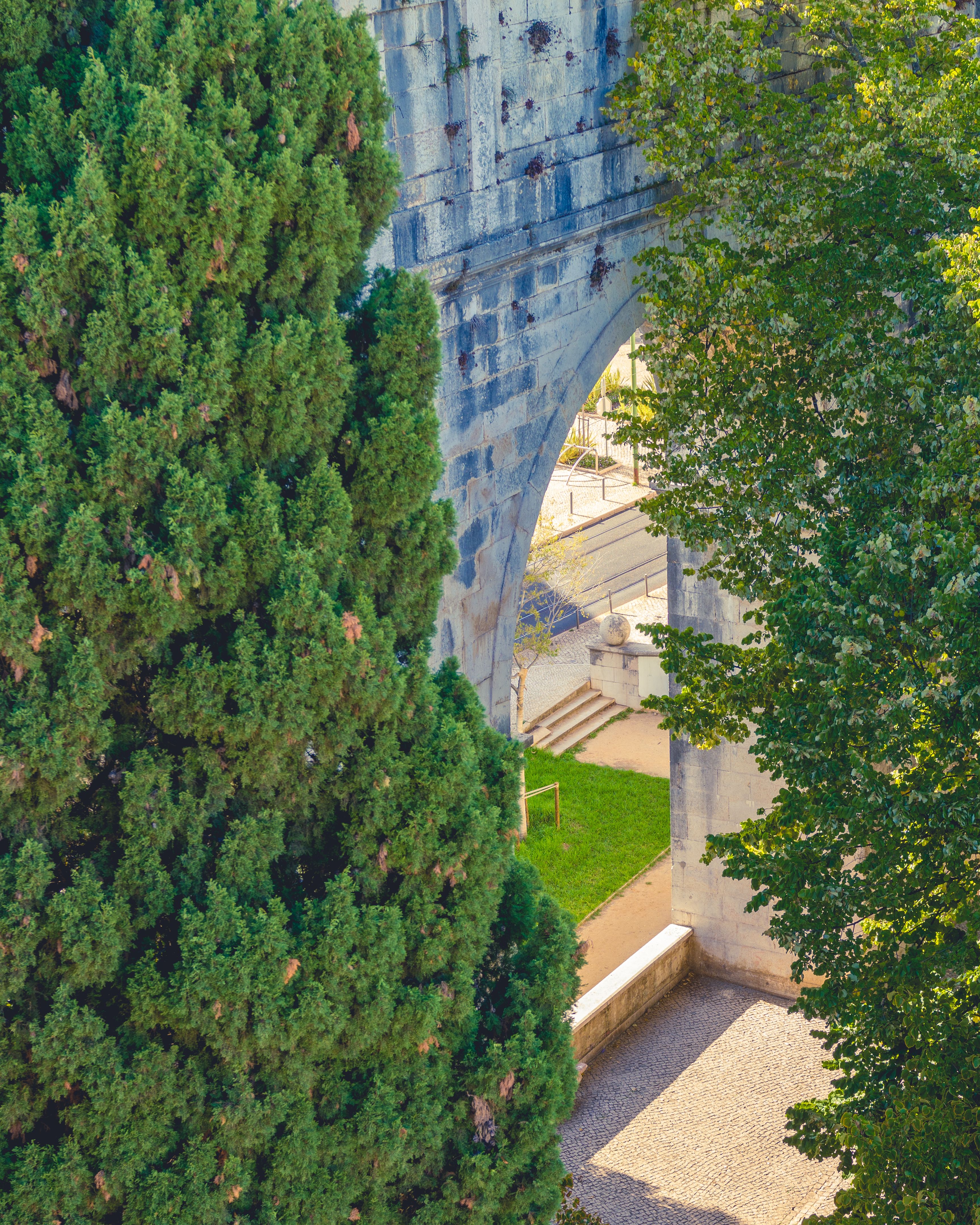 Wall with Arch behind Trees · Free Stock Photo