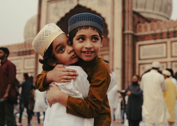 Children Hugging In The Square In Front Of The Mosque