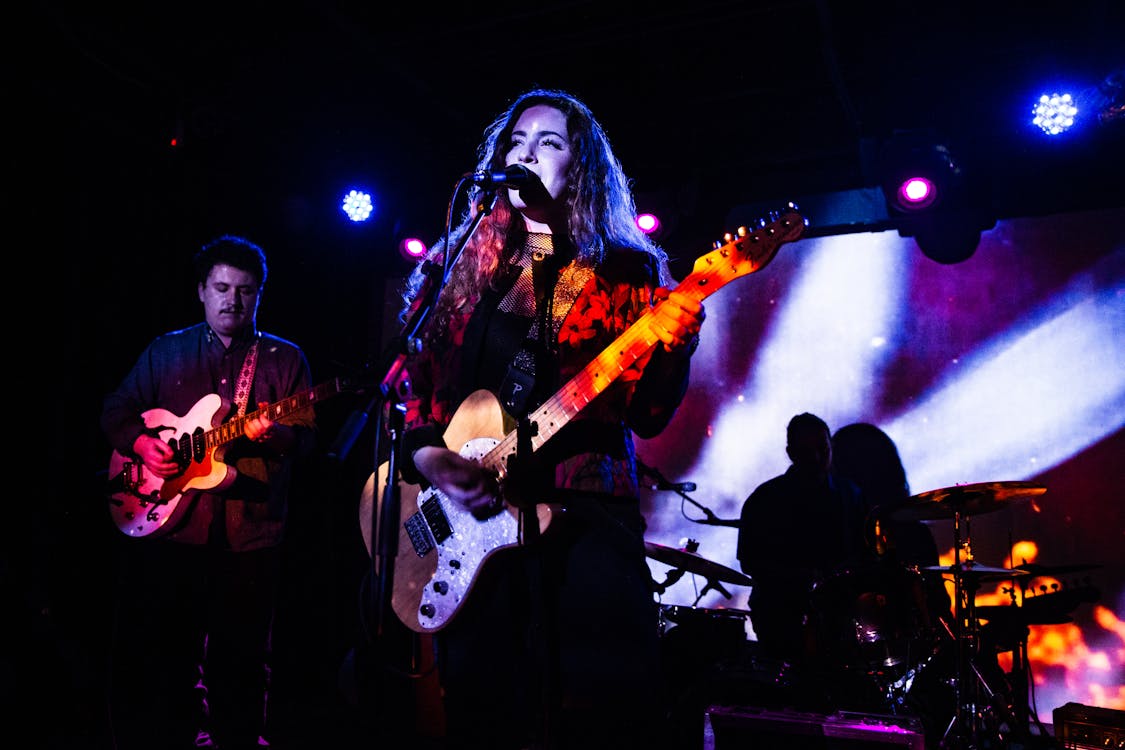  Musical Band Playing Music on Stage With Purple and White Light