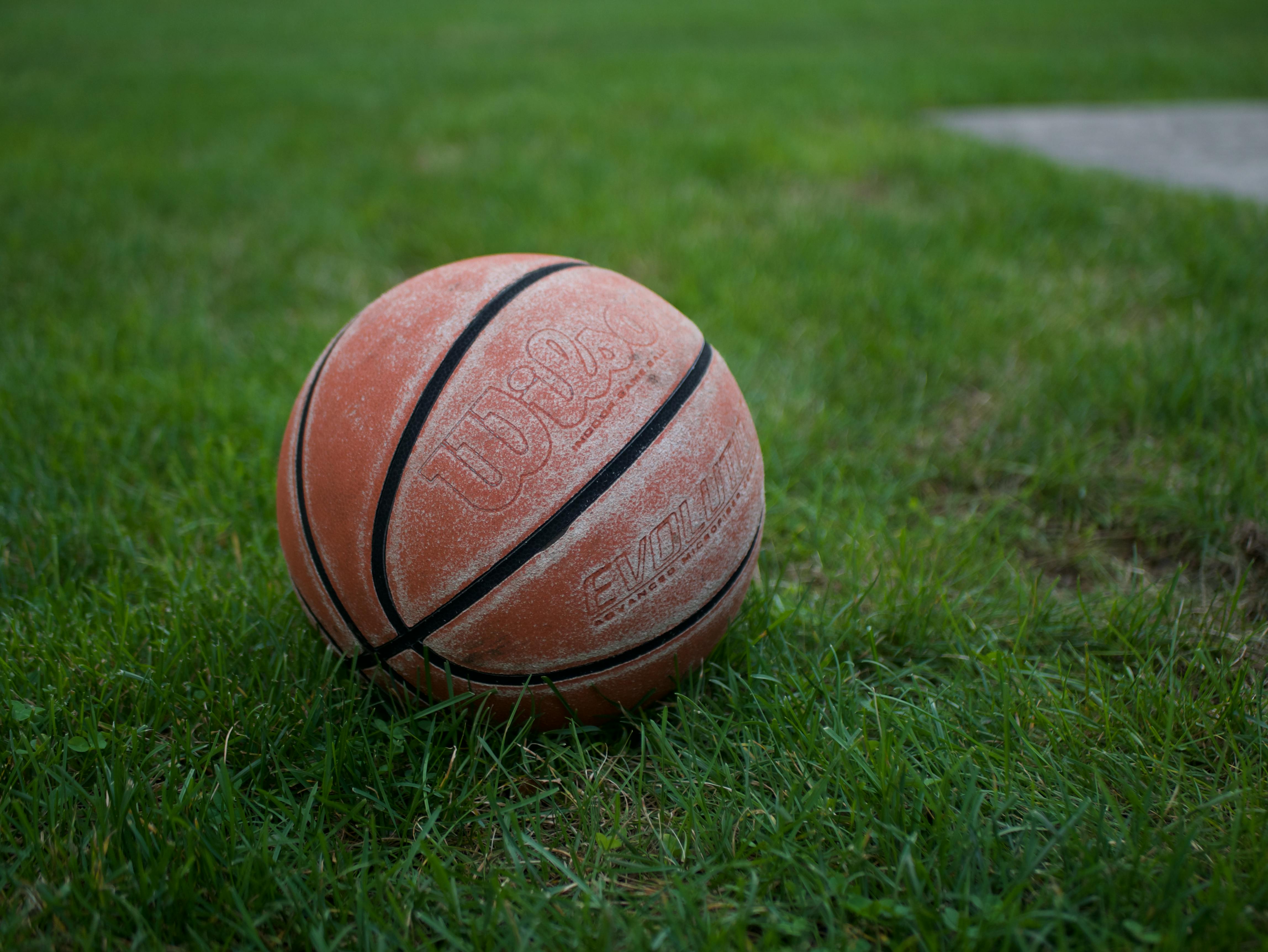 Worn Out Basketball on the Lawn Free Stock Photo