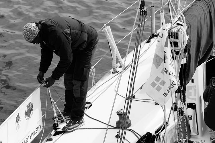 Man In Black Gray Jacket On A Boat's Railing