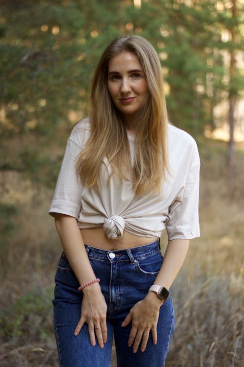 Young Woman in a Casual Outfit Standing in the Forest