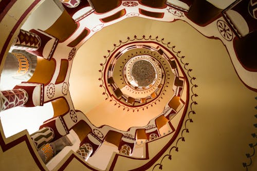 A spiral staircase with red and white designs