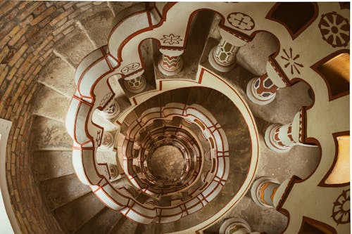 A spiral staircase with a decorative pattern on it