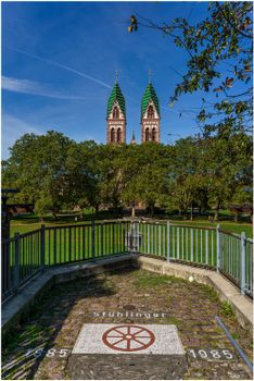 Stunning view of twin gothic church towers in Freiburg's Stühlinger Park.