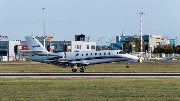 A private jet touches down at Prague International Airport, capturing a moment of travel luxury and sophistication.