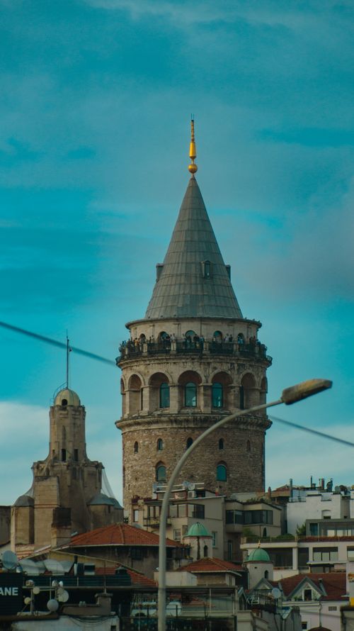 Free A stunning view of the historic Galata Tower in Istanbul under a clear blue sky, showcasing urban architecture. Stock Photo