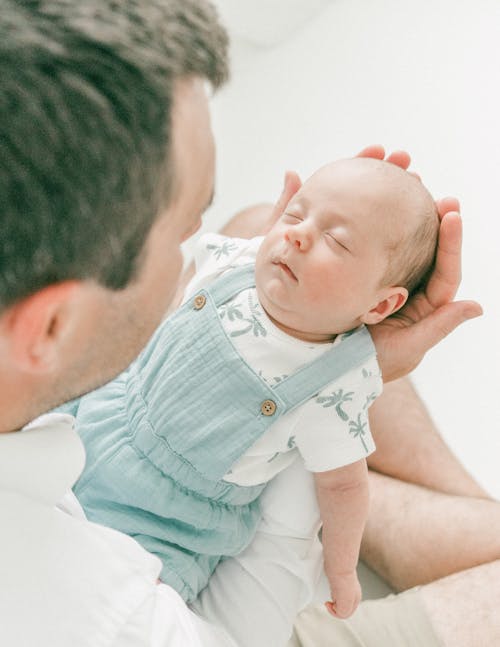 Father Holding Sleeping Baby