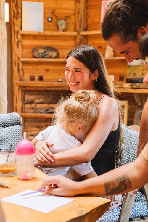 Happy Brunette Woman Embracing Little Girl