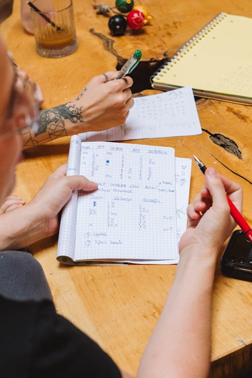 Free Notebook with Notes in Hand Stock Photo