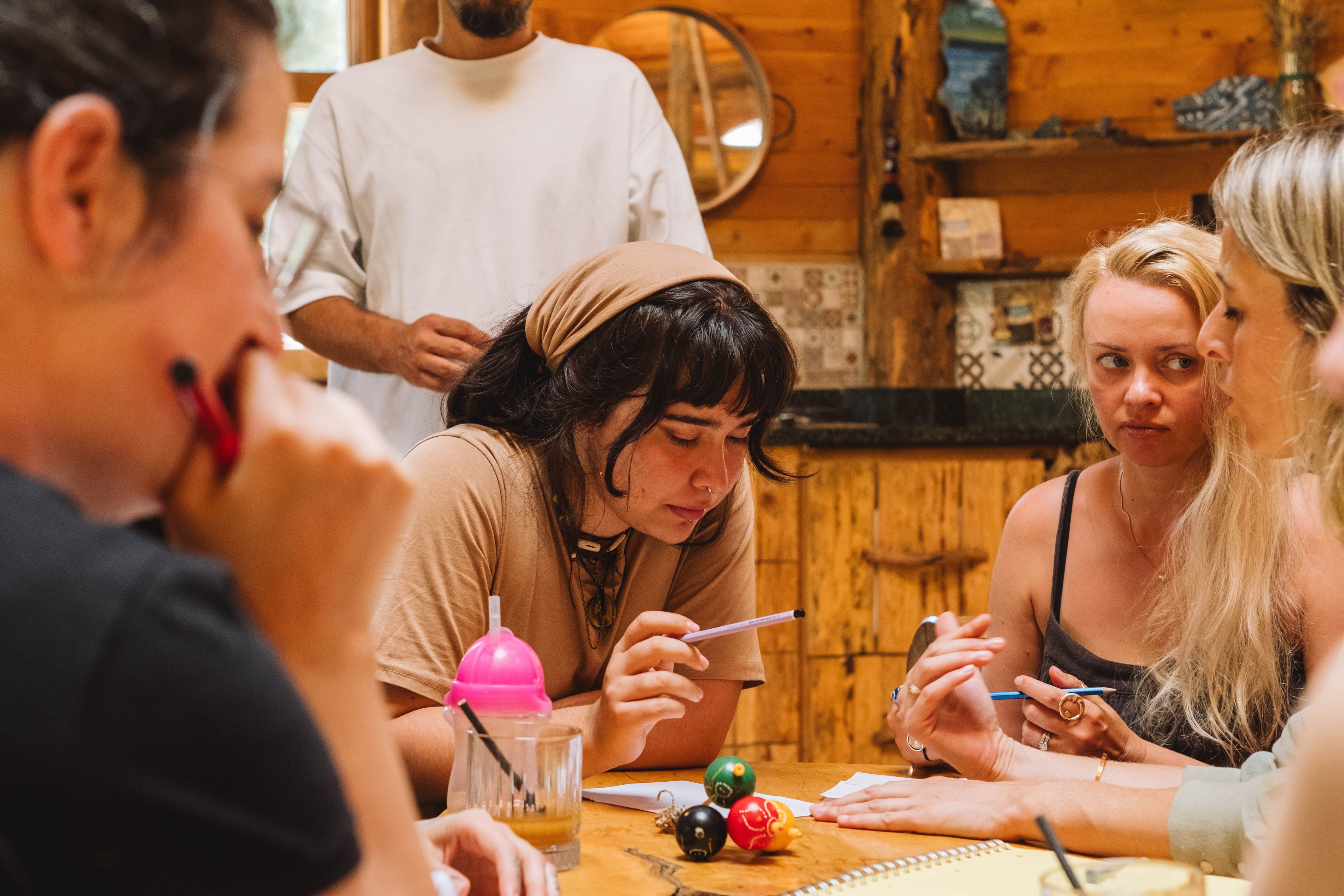 A group of adventurers sitting around a table with papers and dice