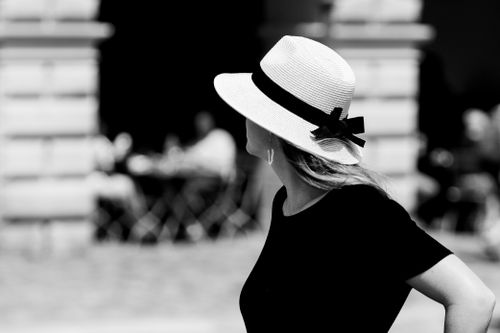 Free Woman in a hat standing on the street in black and white photo. Stock Photo
