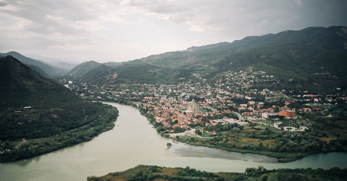 Explore a stunning aerial view of Mtskheta, where the Mtkvari and Aragvi rivers converge in Georgia's scenic landscape.