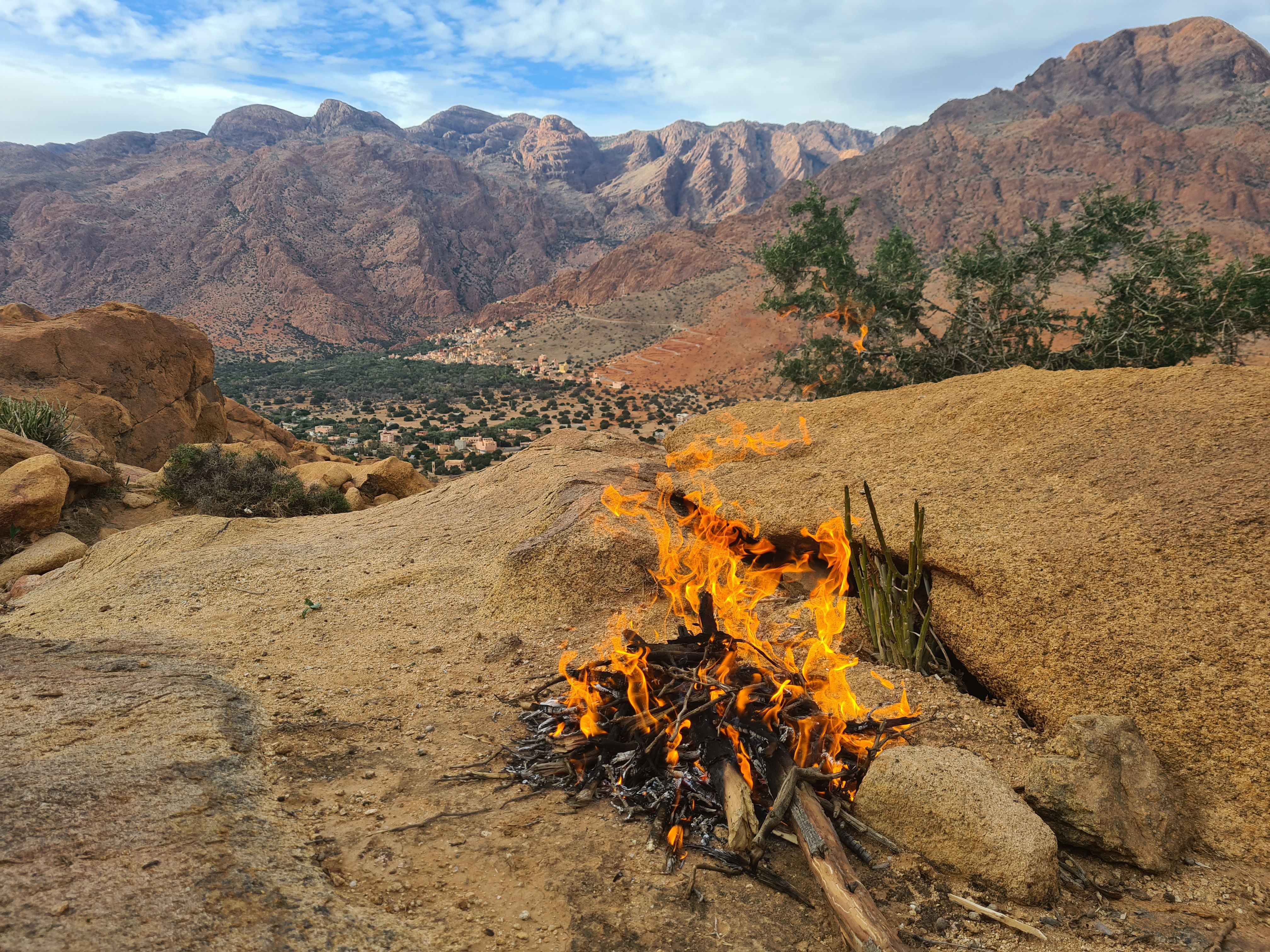 A serene campfire in the rocky mountain landscape of Tafraoute, Morocco.