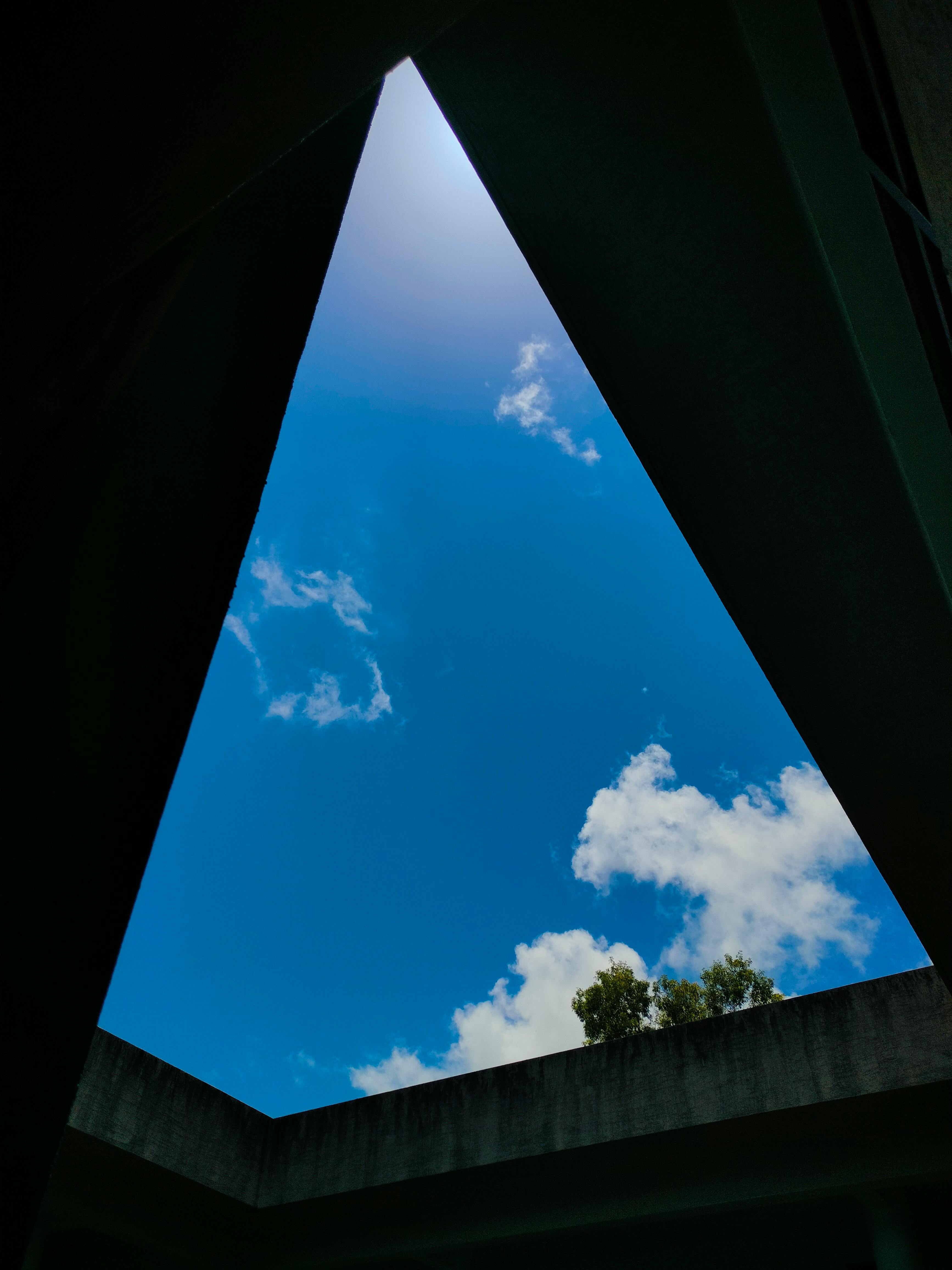 Stunning view of blue sky through triangular courtyard opening in Belagavi, India.