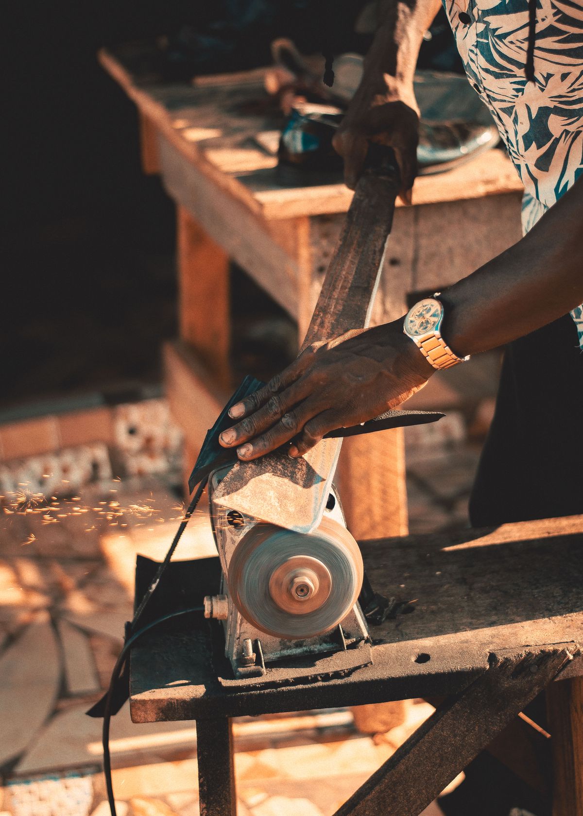 Man Using a Grinder to Make a Tool · Free Stock Photo