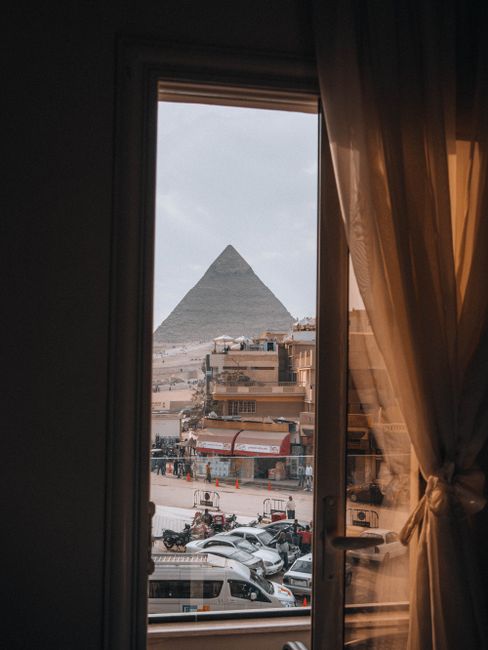 The iconic Great Pyramid of Giza framed through a window in Cairo, Egypt.
