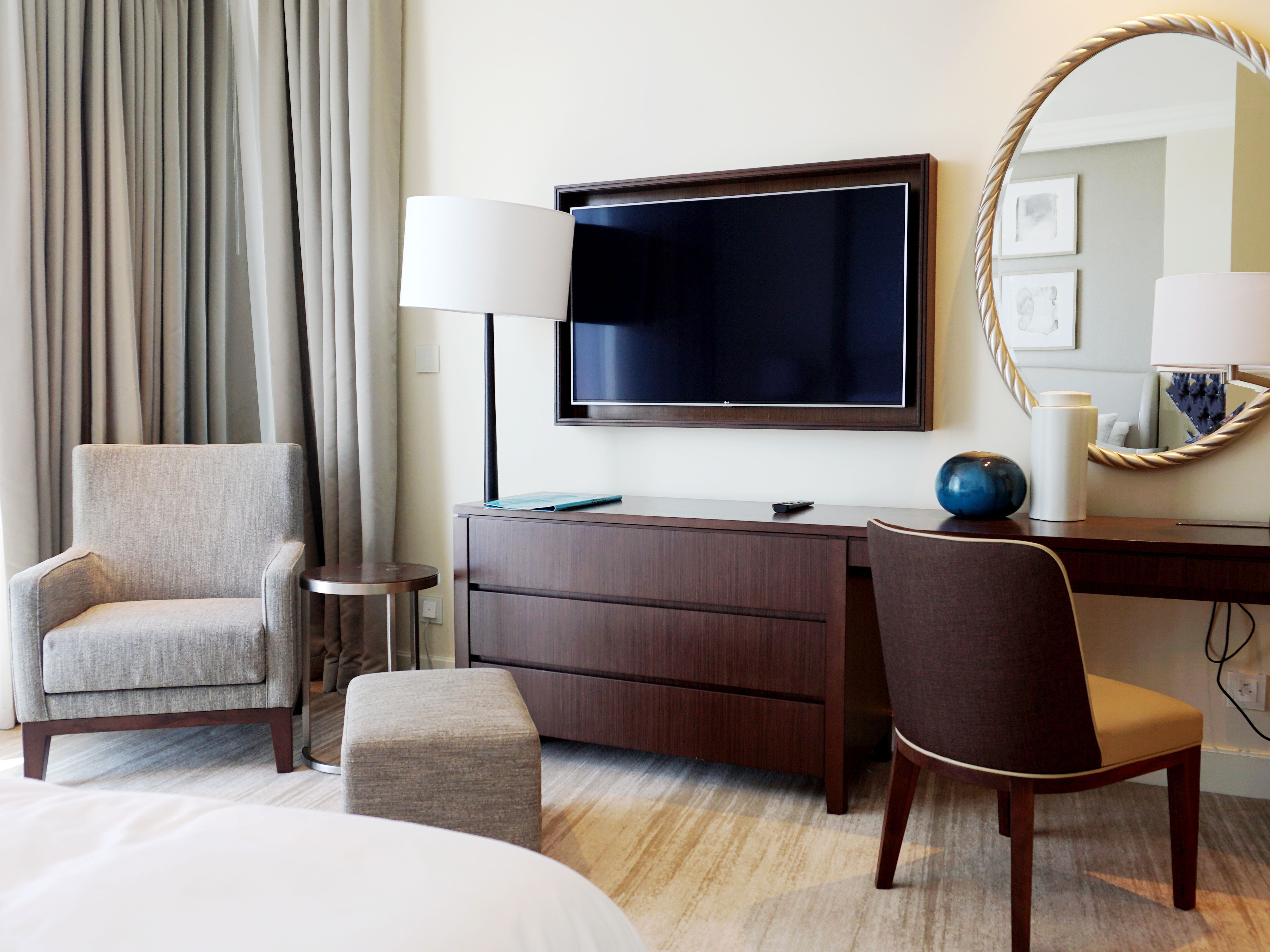 A clean modern hotel room with a large bed and window