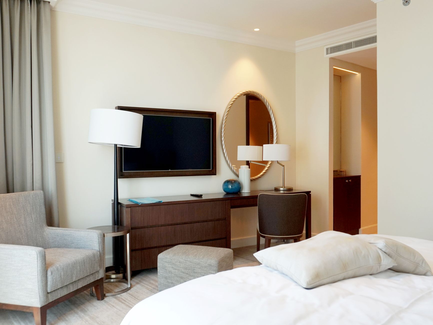 Hotel room with a television, armchair, and comfortable decor