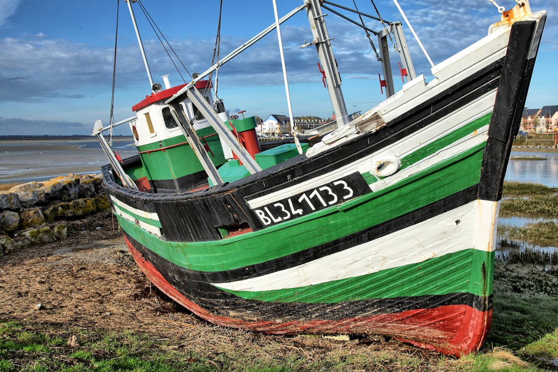 Green Fishing Boat on Shore