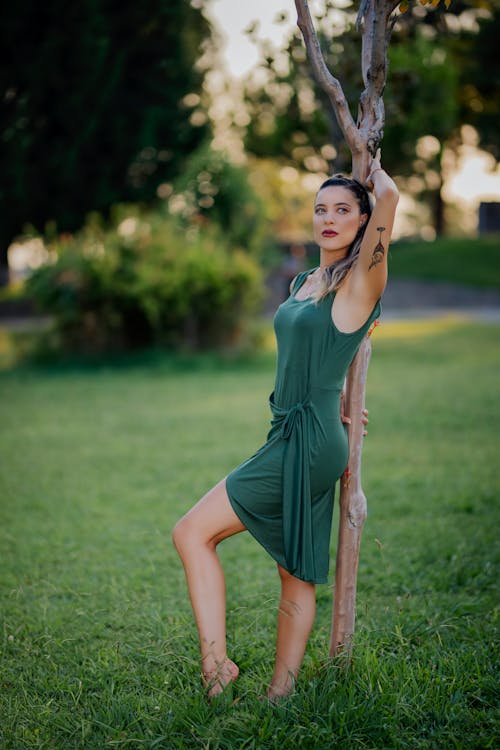 Woman Posing in Green Dress in Park