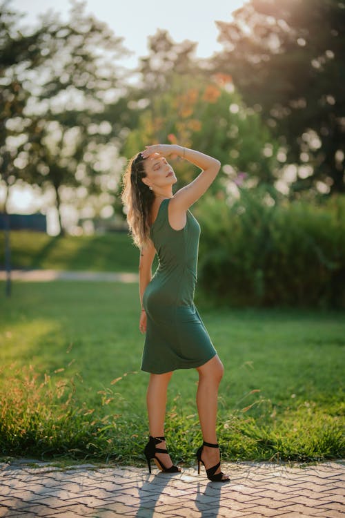 Model Posing in Green Dress in Park